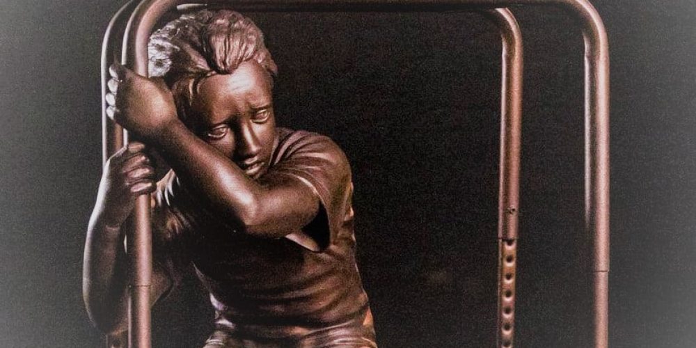 kid under desk statue